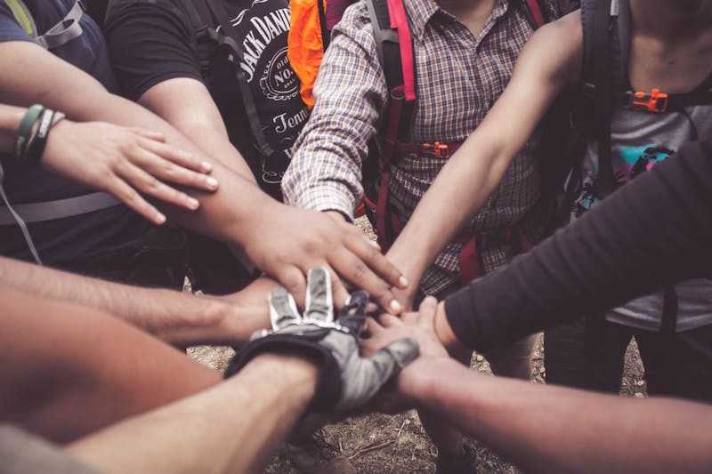 A group of people standing around each other.