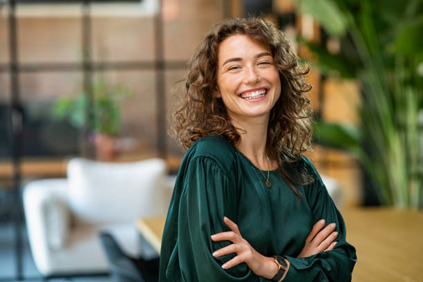 A woman with curly hair smiling for the camera.