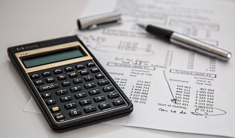 A calculator sitting on top of some papers