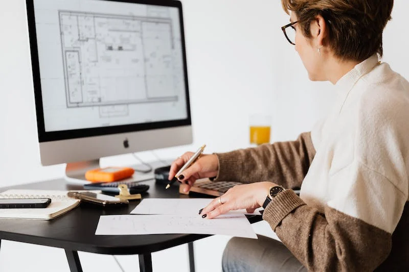 A person sitting at a desk with a computer