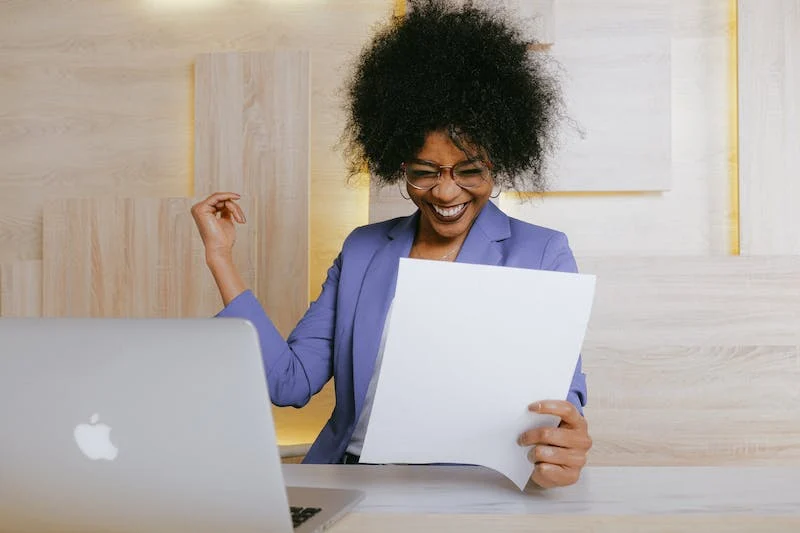 A woman sitting at her desk with papers in front of her.